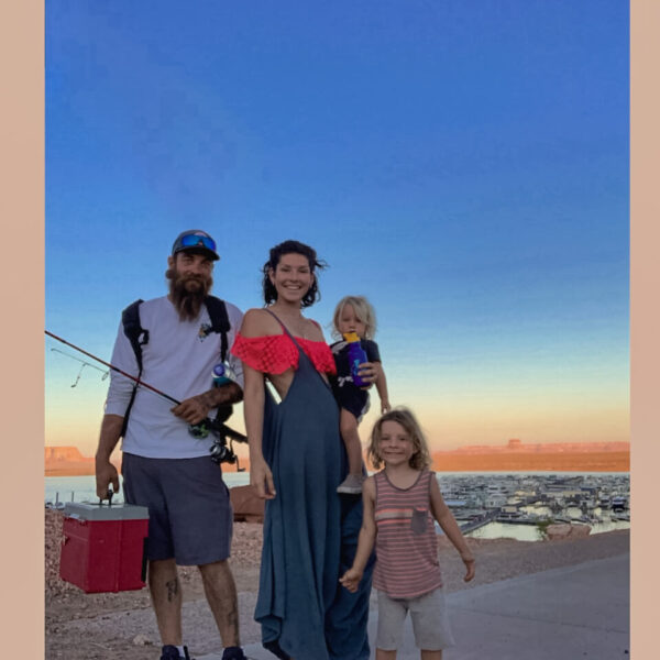 American family fishing with young children smiling