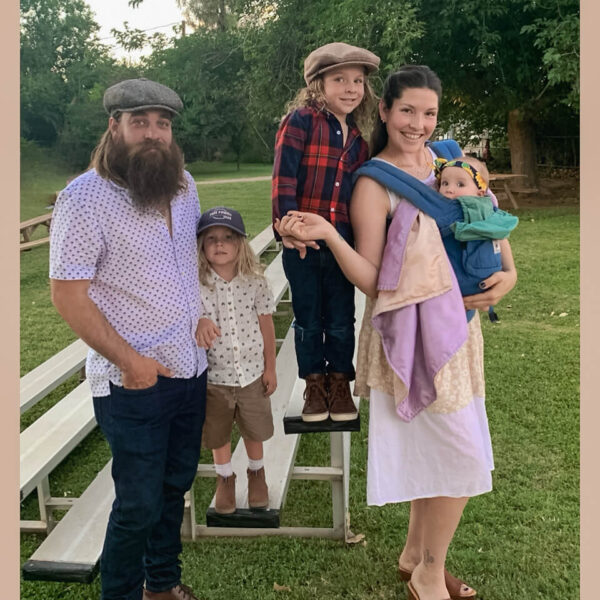 young mother and father with their three young children smiling